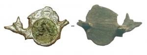 FIB-41646 - fibule zoomorphe : dauphinbronzeBroche plate étamée présentant un dauphin à décor incisé, sous lequel est associé un disque portant un médaillon figuré en tôle estampée.