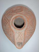 LMP-5148 - Lampe pantoufle byzantineterre cuiteLampe ovoïde à bec à canal - décoré d'une double croix - incorporé. Epaule décorée de traits formant un zigzag en relief. Petite anse conique à l'arrière (perdue).