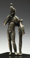 STE-4066 - Statuette : HarpocrateargentHaprocrate est figuré sous la forme d'un jeune adolescent, mince, nu à l'exception d'un manteau jeté sur l'épaule gauche, et coiffé d'une feuille de lotus (?); le poids du corps est déporté sur la jambe droite: il porte l'index droit à sa bouche tandis que la main gauche tient un oiseau posés sur une sorte de tronc sinueux.