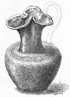 CRU-4011 - Cruche de type Tassinari D.2100bronzeTPQ : -30 - TAQ : 40Cruche martelée, à épaule marquée, col cylindrique (épaule horizontale) et bec bilobé très étranglé ; le fond, souvent renforcé sur un anneau porteur, garde les traces de la finition au tour. Anse coulée, dont le poucier a généralement la forme d'un buste féminin (parfois, Minerve casquée) surplombant l'embouchure; à la base, tête barbue et moustachue (Satyre).