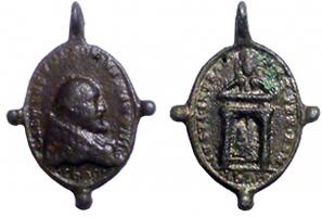 MER-9001 - Médaille religieuse : Clément VIIIbronzeMédaille ovale, moulée, pourvue de trois boutons dessinant une croix avec la suspension; d'un côté, buste du pape Clément VIII, autour, inscription; de l'autre, porte ouverte du Vatican, inscription.