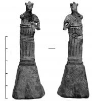 STE-4192 - Statuette : Athena ParthenosplombStatuette en plomb de facture rustique; le socle se réduit à une simple pyramide, et la silhouette reproduit à grands traits celle de la statue d'Athena Parthenos, le bouclier posé au sol à sa gauche.