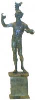 STE-4196 - Statue ou statuette : Arès - Mars nu s'appuyant sur une lancebronzeTPQ : 1 - TAQ : 200Statue ou statuette figurant le dieu Mars représenté de face, déhanché sur la gauche, nu, le bras droit levé, appuyé sur une lance tandis que le bras gauche ramené devant lui reposait sur un bouclier, posé ou sol, ou présentait une épée. Le casque souvent coulé à part, sur les grandes statues, est rapporté sur la tête. 