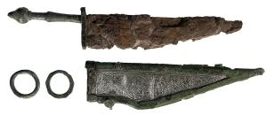 CTO-4094 - Couteau de type Simancasfer, bronzeCouteau à lame triangulaire et fil sinusoïdal, dos rectiligne, manche de bronze et mitre, associé à un fourreau métallique  à gouttières et bouterolle, suspendu à des anneaux latéraux comme les armes militaires.