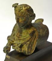 ACH-4034 - Applique de charbronzeTPQ : 1 - TAQ : 300Douile cylindrique horizontale, refermée à une extrémité par un buste de Flore : déesse féminine portant des fleurs et tendant un fruit dans la main droite ; fleurs dans la chevelure.