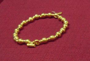BRC-3021 - BraceletorBracelet formé de perles en oves encadrées d'annelés séparés par une gorge, sur fil métallique (?), avec fermoir.