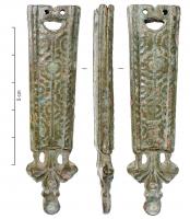 FRT-9010 - Ferret de ceinturebronzeTPQ : 1450 - TAQ : 1650Ferrete en deux parties plates, découpées et accolées, maintenues par 4 rivets enserrant l'extréité de la lanière; corps rectangulaire allongé, avec motifs floraux; ajour sommital; base ajourée avec lest.