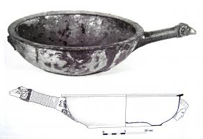 PAT-3001 - Patère
bronze
Patère à vasque profonde, lèvre aplatie déversée à l'intérieur et à l'extérieur; le fond repose sur un pied annulaire ; le manche cannelé transversalements se termine par une tête de bélier; à l'opposé, masque humain.