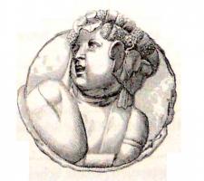 PHA-4022 - Phalère : buste d'enfant bachiquebronze, plomb, argentPhalère à décor figuré : buste d'enfant, aux traits classiques, feuilles de vigne et grappes de raison dans la chevelure.