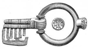 CLE-5002 - Clé-sceau articulée à mouvement rotatifbronzeClé à rotation, anneau rotatif, tige à panneton perpendiculaire ajouré de plusieurs motifs complexes; à l'opposé, une excroissance axiale tronconique forme un sceau-matrice, inscrit en lettres grecques.