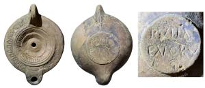 LMP-42688 - Lampe à bec cordiforme, ombilic central : PVLLA / ENORVterre cuiteTPQ : 150 - TAQ : 250Lampe moulée, anse verticale percée à deux sillons sur la tranche. Réservoir circulaire à profil biconvexe, décor d'oves sur l'épaule. Disque en simple cuvette limitée par deux sillons et un anneau de stries rayonnantes. Ombilic central strié et percé. Bec arrondi. Base circulaire plate en léger relief limitée par un anneau plat souligné par deux sillons concentriques. Marque incisée PVLL A / ENORV(m).