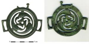 JHA-4022 - Jonction de harnaisbronzeJonction circulaire avec trois bélières réctangulaires régulièrement réparties sur le bord externe; décor ajouré composé de trois motifs curvilignes (en formes de gouttes ou motifs végétaux) disposées en mouvement circulaire, séparés par des ajours.