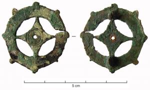 FIB-4107 - Fibule géométrique plate
bronze
TPQ : 40 - TAQ : 70
Fibule plate, dont la charnière disposée au revers comporte deux plaquettes coulées reliées par un axe en fer. Variante comportant un losange inscrit dans un cercle, avec de petits fleurons sur le pourtour ; décor central de cercles concentriques avec motif perlé et, souvent, un cabochon incrusté au centre.