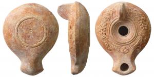 LMP-4098 - Lampe syro-palestinienne
terre cuite
TPQ : 100 - TAQ : 300
Lampe moulée à anse verticale non percée; bec en bras d'ancre; petit disque sans décor, mais couronne moulée de palme et dattes sur le bandeau, une fleur au départ du bec. Base en bourrelet souligné par deux sillons, petit cercle en creux au centre.