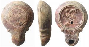 LMP-41531 - Lampe bec a volutes doubles : L M ADIEC Aigle
terre cuite
TPQ : 90 - TAQ : 140
Lampe moulée, sans anse. Réservoir circulaire de profil convexe. Bandeau étroit penché vers l'extérieur. Disque en cuvette limitée par un cercle en creux. Décor : aigle déployant ses ailes. Bec long arrondi, flanqué de deux volutes doubles se poursuivant sous le bec. Base plate limitée par un sillon, signée L M ADIEC.