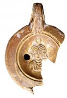 LMP-42193 - Lampe à bec rond limité par un trait : Buste de Luna, croissant
terre cuite
TPQ : 60 - TAQ : 150
Lampe moulée, anse verticale percée, à deux sillons sur la tranche. Réservoir circulaire à profil biconvexe. Bandeau lisse, penché vers l'extérieur. Disque en cuvette limitée par deux sillons concentriques; décor : buste féminin de face, surmonté d'un croissant aux pointes dressées vers le haut (Luna). Bec arrondi limité par un trait. Base circulaire plate en léger relief limitée par un sillon, marque cursive. Restes d'engobe brun sur toute la lampe.