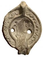 LMP-5279 - Lampe Hayes II : Jonas et baleineterre cuiteTPQ : 525 - TAQ : 550Lampe moulée à anse verticale pleine. Bec long à canal. Alternance de motifs moulés sur le bandeau (Bussière M & V). Sur le disque, Jonas couché sous le cucurbite, devant la baleine sous la forme d'un monstre à long cou et tête barbue retournée vers l'arrière. Base circulaire à patère contenant deux cercles gravés concentriques.