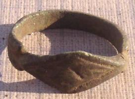 BAG-9031 - BaguebronzeBague à jonc plat, dont le chaton bien délimité par des encoches s'élargit pour former une surface losangique allongée, à décor gravé.