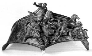BTU-4001 - BalteusbronzeBaudrier ornemental (balteus) placé sur le poitrail d'un cheval pour une manifestation publique (triomphe, défilé honorifique...). Le balteus se présente sous la forme d'une bande horizontale, approximativement losangique (pointe axiale vers le haut), sur laquelle sont rivetés les éléments d'un décor de type triomphal : le plus souvent, scènes de bataille ou de victoire avec corps-à-corps, prisonniers, imperator recevant la soumission des vaincus, etc.