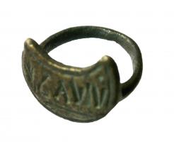 SIG-4028 - Signaculum en forme de lunulebronzeTPQ : 200 - TAQ : 400Signaculum coulé, en forme de lunule creusée pour dégager une inscription rétrograde, lettres en creux. Au revers, anneau gracile formant bague.