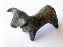 STE-1001 - Statuette zoomorphe : bovidébronzeTPQ : -2300 - TAQ : -2000Figurine de bovidé au corps massif, larges cornes, les pattes réduites à des moignons couts ; les volumes sont schématisés au profit des transitions curvilignes entre les différentes parties du corps.