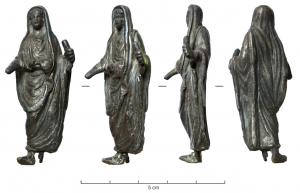 STE-4054 - Statuette : prêtreargentTPQ : -30 - TAQ : 300Prêtre officiant, caractérisé par sa toge dont un bord vient recouvrir la tête; la main droite effectue une offrande, la gauche peut tenir divers objets (souvent, un coffret de boules d'encens).