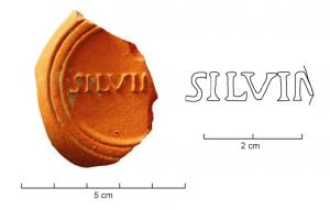LMP-42479 - Lampe de firme : SILVINIterre cuiteTPQ : 75 - TAQ : 200Lampe moulée sans anse: le réservoir circulaire est de profil biconvexe asymétrique; bandeau penché vers l'extérieur portant deux tenons rectangulaires non percés, sur l'axe horizontal. Disque en cuvette profonde bordée par un bourrelet continu. Bec long au petit canal communiquant avec le disque, chanfeiné sur les côtés. Base circulaire plate en creux limitée par deux anneaux concentriques enfermant la marque moulée SILVINI en relief. Engobe jaune orangé granuleux, peu adhérent.