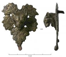 APM-4069 - Applique de meublebronzeApplique en forme de feuille de vigne, au contour découper et à la surface nervurée, percée de quatre perforations circulaires régulièrement répartis; du centre de la feuille émerge une tête de fauve (lion ?) en haut-relief; tiges de fixation au revers, pour un support en bois.