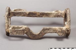CAT-4001 - Armature de ressort de catapulteferRobuste cadre en fer d\'un ressort de catapulte, constitué d\'un faisceau de tendons animaux enroulés en faisceau entre deux cercles parallèles, qui permettent un serrage et un blocage de l\'ensemble. Les disques sont reliés par deux fortes barres, dont l\'une est encochée pour le passage du bras de la catapulte lorsqu\'il se détend.
