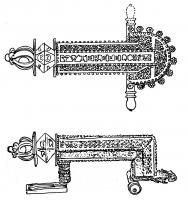 FIB-4005 - Fibule en genou (Kniefibel)bronzeFibule en genou dont l'arc suit un parcours à angle droit ; inscription VTERE FELIX ajourée sur le dessus de l'arc ; bras transversal terminé par des boutons moulurés, avec à la tête une plaque en demi-cercle avec fleurons.
