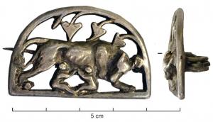 FIB-41635 - Fibule zoomorphe, groupe : Louve et JumeauxargentDans un cadre en demi-cercle, une louve debout vers la droite allaite deux jumeaux se faisant face; au-dessus, feuilles de lierre; au revers, articulation à ressort sur axe, monté sur une plaquette coulée.