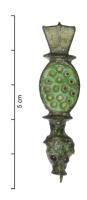 FIB-4650 - Fibule émailléebronzeFibule émaillée, dont le pied se termine presque toujours par une tête de reptile stylisée, dont les yeux peuvent recevoir de petites billes de verre (soit par un agencement de triangles émaillés). L'arc est remplacé par une plaque circulaire, ovale ou hexagonale, ornée d'émaux rayonnants, éventuellement accostée de cabochons. La plaque de tête, qui évoque une nageoire, comporte deux loges trapézoïdales émaillées.