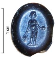 INT-4019 - Intaille : Fides PublicanicoloIntaille ovale en nicolo, variété de calcédoine ; divinité féminine nue se tenant debout de face ; dans sa main droite des épis de blé entourant un pavot ; une patera ou un globe dans sa main gauche ; attributs de la déesse Fides Publica.