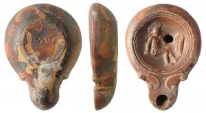 LMP-41532 - Lampe Loeschcke IV : Gladiateur, LMCterre cuiteMoulée, sans anse. Réservoir circulaire de profil convexe. Bandeau étroit penché vers l'extérieur. Disque en cuvette limitée par deux sillons. Décor : gladiateur thrace vaincu  à droite, assis devant son bouclier. Bec long arrondi, flanqué de deux volutes doublesse poursuivant sous le bec. Base plate circulaire limitée par un sillon, marque gravée L.M.C en creux. Engobe marron rouge.