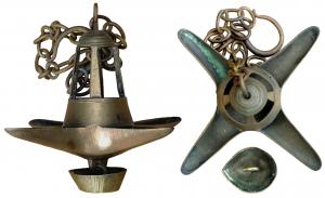 LMP-8001 - Lampe lanternon à quatre becs, en bronzebronzeLampe en bronze composée d'un lanternon tronconique ajouré reposant sur un réservoir à quatre becs. Sous la lampe est suspendu un récipient en forme de goutte, appelé goutteuse ou leuceron, servant à recueillir l'huile qui peut suinter de la lampe. Longue chaîne de suspension.