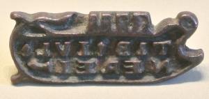 SIG-4019 - Signaculum en forme de bateaubronzeTPQ : 300 - TAQ : 500Matrice en forme de bateau, comportant un nom en lettre rétrogrades, généralement sur deux lignes, dans un cadre épousant la forme du cachet.