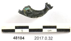 APH-4246 - Applique de harnais delphiniforme émailléebronze, verreApplique figurant un dauphin, dans un cas à décor émaillé dont il reste un fragment bleu clair. Au revers, deux tiges de fixation. 