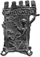 ESP-7056 - Enseigne de pèlerinage : saint Léonard de NoblatplombEnseigne en forme de donjon crénelé : saint Léonard debout à droite, auréolé, bénit un prisonnier agenoulé devant lui; entrave suspendue au mur, une autre au sol; inscription sur le mâchicoulis : S:LEONARD.